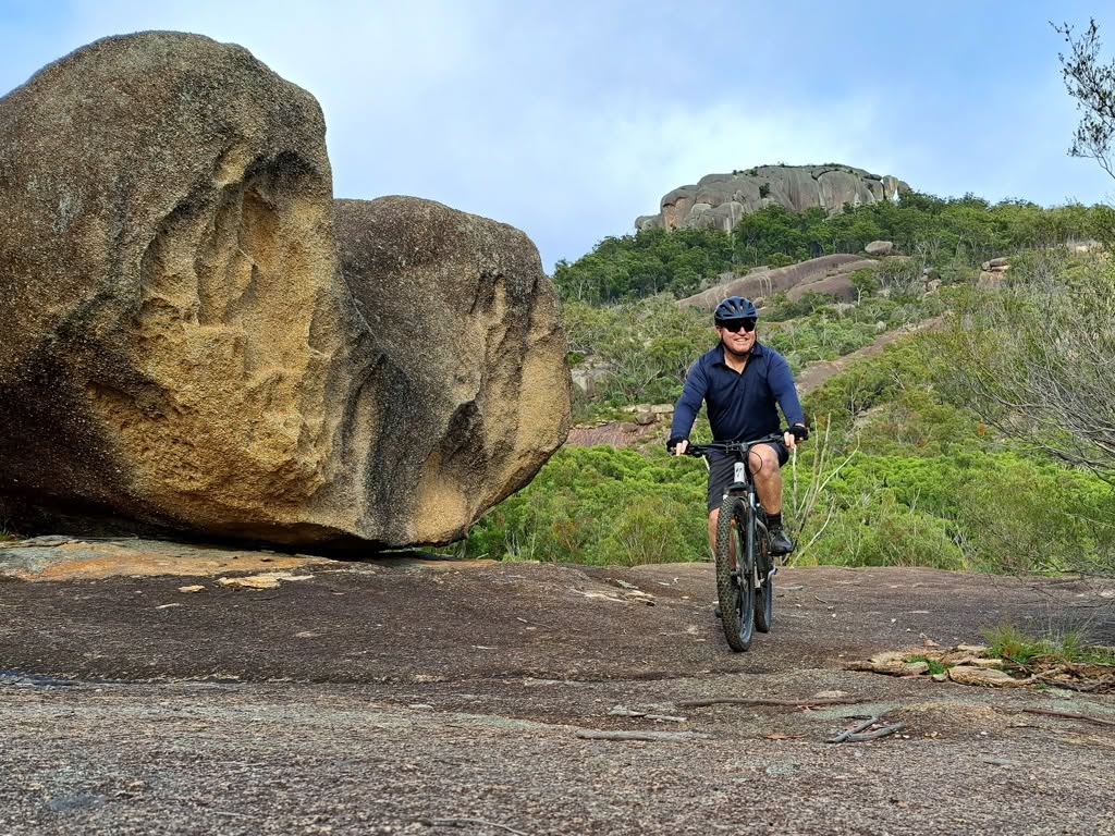Girraween National Park MTB Mountain biker riding across a gravel platform in Girraween National Park