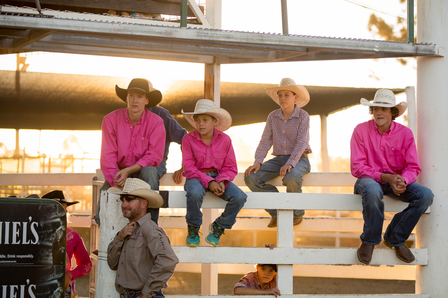 Cowboys sitting on a fence at the Warwick Rodeo